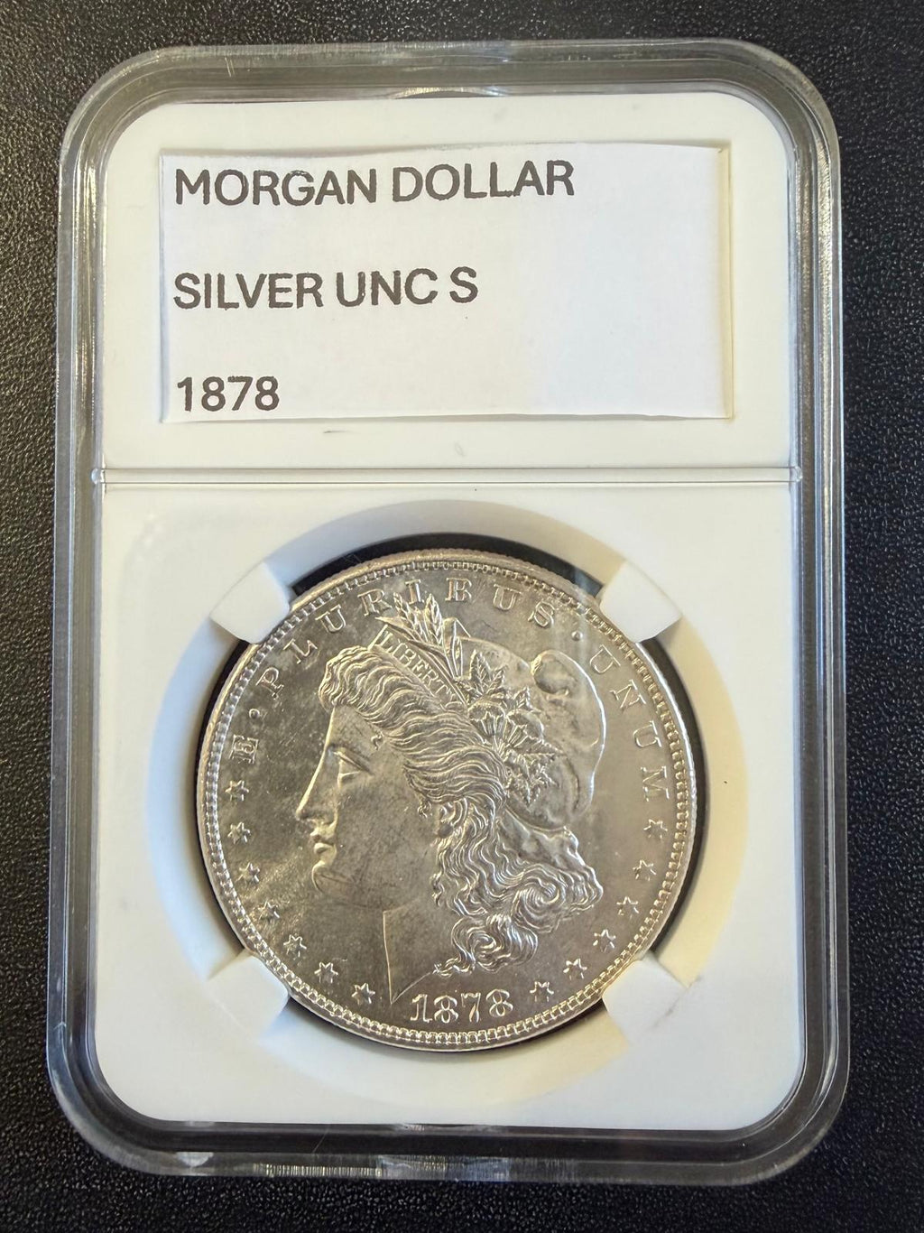 Dólar Morgan de 1878-S, reverso estándar de 7 plumas de cola de 1878, aproximadamente MS62–MS63.